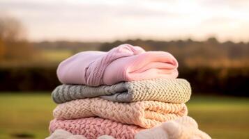 Laundry, housekeeping and homemaking, stack of clean and folded knitted clothes in the countryside, photo