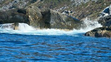 norway on the fjord, spray on rocks. Water splashes on the stones. Coastal landscape photo