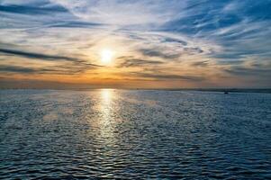 Sunset, illuminated sea. Light waves. Poel island on the Baltic Sea. Nature photo