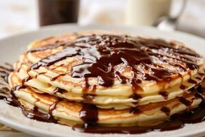 stock photo of warm pancake with chocolate syrup food photography