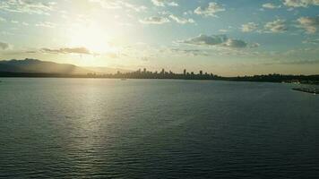 Vancouver skyline silhouettes in beautiful morning light, aerial view video