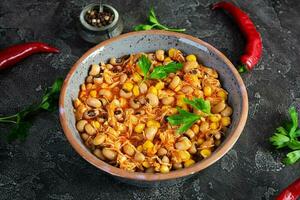 Chili con carne in a bowl. Mexican cuisine. Chili with meat, corn and beans photo