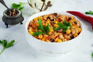 Chili con carne in a bowl. Mexican cuisine. Chili with meat, corn and beans photo