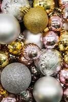 Christmas ornament. Pile of silver, gold and pink Christmas balls photo