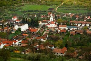 Rimetea is a small village located in Transylvania, Romania. It is situated in the Apuseni Mountains and is known for its picturesque setting and well preserved Hungarian architectural style. photo