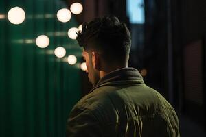 back view of a man walking on the street at the night. photo