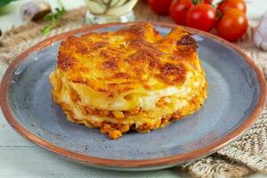 Classic lasagna with minced chiken bolognese sauce and bechamel sauce photo