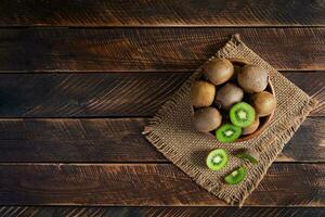 Kiwi fruit on wooden background. Juicy kiwifruit photo