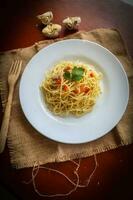 aglio e olio. Italian Pasta Spaghetti, aglio olio e pepperoni ,spaghetti with garlics, olive oil and chilli peppers on plate on table photo