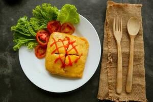 nasi goreng pattaya or Pattaya Fried Rice, Stuffed Omelette Fried Rice. Southeast Asian dish made by covering or wrapping chicken fried rice, in thin fried egg or omelette photo