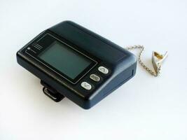 Side view, Vintage model of Wireless telecommunication, pager, paging, message device, communication, beeper, isolated on white background photo