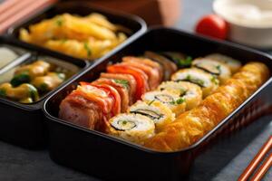 stock photo of Tamagoyaki Japanese Rolled omelette in bento with rice food photography