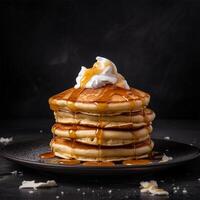 Homemade pancakes with butter and maple syrup on a plate, side view. Close-up. . photo