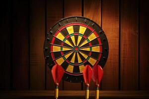 A Colorful Dartboards with Three Darts Missed Off on Brown Wooden Background. . photo