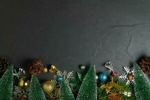 Christmas background with decorations on black stone table background, photo