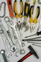 Set of tools for construction or the house. Wrench, pliers, hammer, screwdriver, flashlight, bold, scissors, knife and others. photo