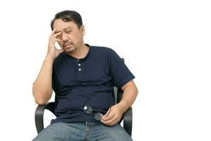 Middle-aged man sitting on chair and feeling stressed and headache isolated on white photo