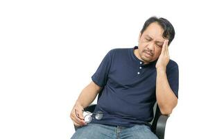 Middle-aged man sitting on chair and feeling stressed and headache isolated photo