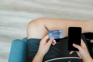 Hand holding credit card and white screen  mobile phone, shopping online photo