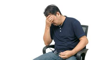 Middle-aged man sitting on chair and feeling stressed and headache isolated photo