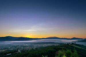 Sunrise and sea of clouds over Pai District at sunrise from Yun Lai Viewpoint. photo