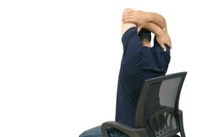 Back side of man stretching arm to relax muscle of shoulder blades sitting on chair photo