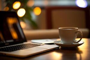 Capture the essence of a cafe scene with this image of a laptop resting on a table alongside a cup of coffee, set against a blurred background photo