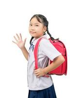 asiático niña estudiante yendo a colegio y ondulación adiós aislado foto