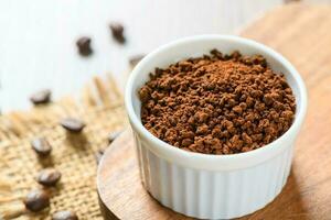 Instant Coffee in small bowl on wood block, photo