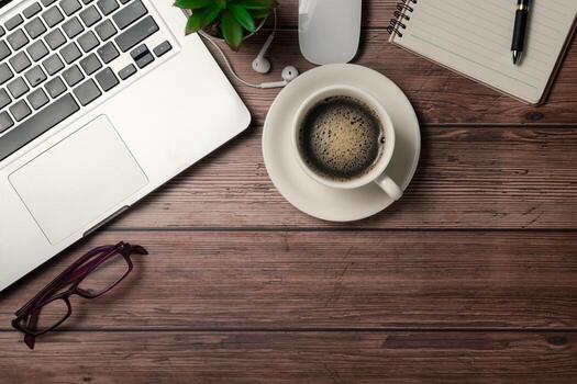 Old wood desk table with black coffee  and laptop computer photo