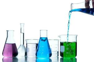 Scientist put blue liquid into measuring beaker  with laboratory glassware photo