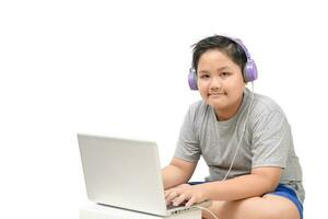 Obese boy student wear headphone study online at home photo