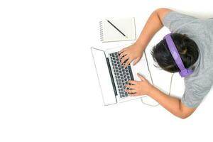 Happy boy student playing computer with headsets and enjoy online learning photo