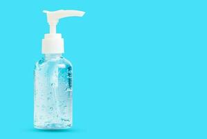 Hand sanitizer bottle or alcohol gel isolated on  blue background photo