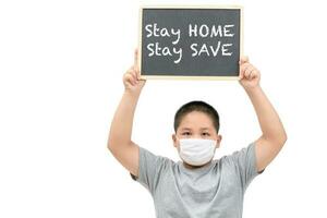 Obese fat boy wear mask shows blackboard with stay home stay save words photo