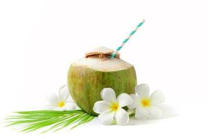 Fresh coconut drink with plumeria flower and paper straw photo