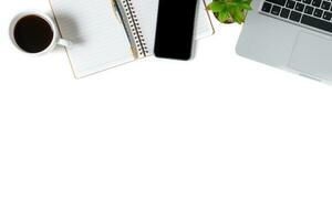 White office desk table with laptop computer, coffee and smartphone. photo