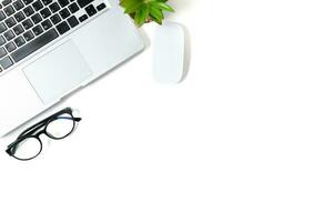 White office desk table with laptop computer photo