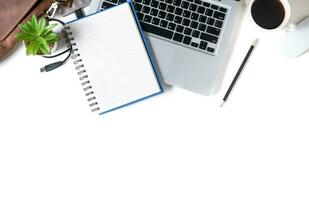 White office desk table Blank notebook with laptop computer, photo