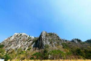 Limestone mountains on blue sky background photo