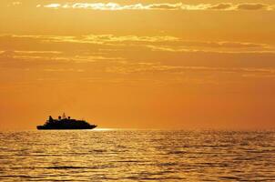 Passenger ship at sunset photo