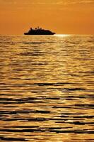 Passenger ship at sunset photo