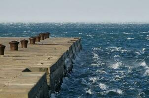 Waves against pier photo