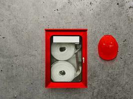 Fire hose cabinet and safety helmet in office building for fire protection preparation photo