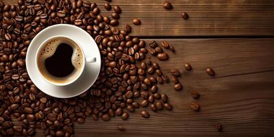 Top View Temptation. Coffee Cup on a Wooden Table with Coffee Beans photo