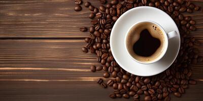 Top View Temptation. Coffee Cup on a Wooden Table with Coffee Beans photo