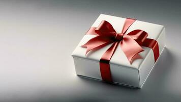 3D Render of White Gift Box With Red Silk Bow Ribbon On Grey Background And Copy Space. photo