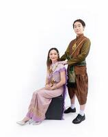 Couple of husband and wife wearing Thai traditional clothes isolated on the white background photo