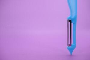 blue paring knife isolated purple background. kpas knife taken with a landscape angle. photo