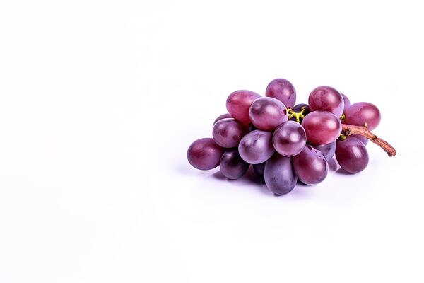 Bunch of ripe red grapes isolated on white background with copy space.
